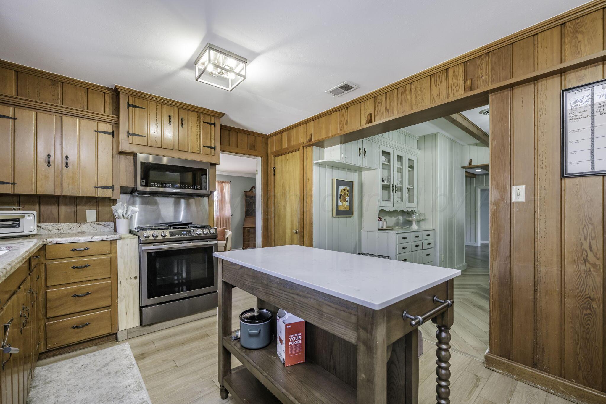 3228 South Travis Street Amarillo, TX 79109 - Photo 8 of 22 a kitchen with a stove a sink and a refrigerator