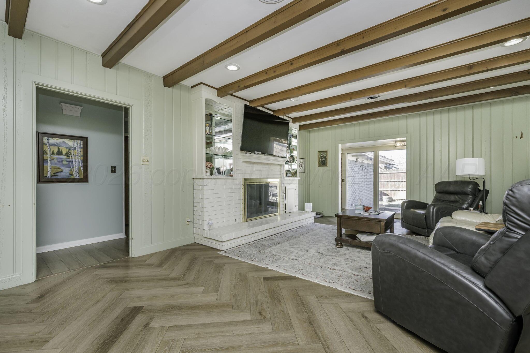 3228 South Travis Street Amarillo, TX 79109 - Photo 10 of 22 a living room with furniture and a fireplace