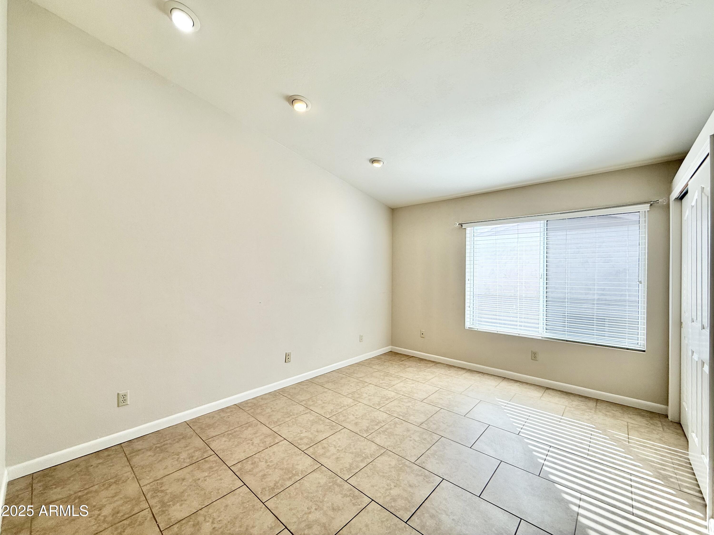 2718 East Bighorn Avenue Phoenix, AZ 85048 - Photo 11 of 31 a view of an empty room with a window