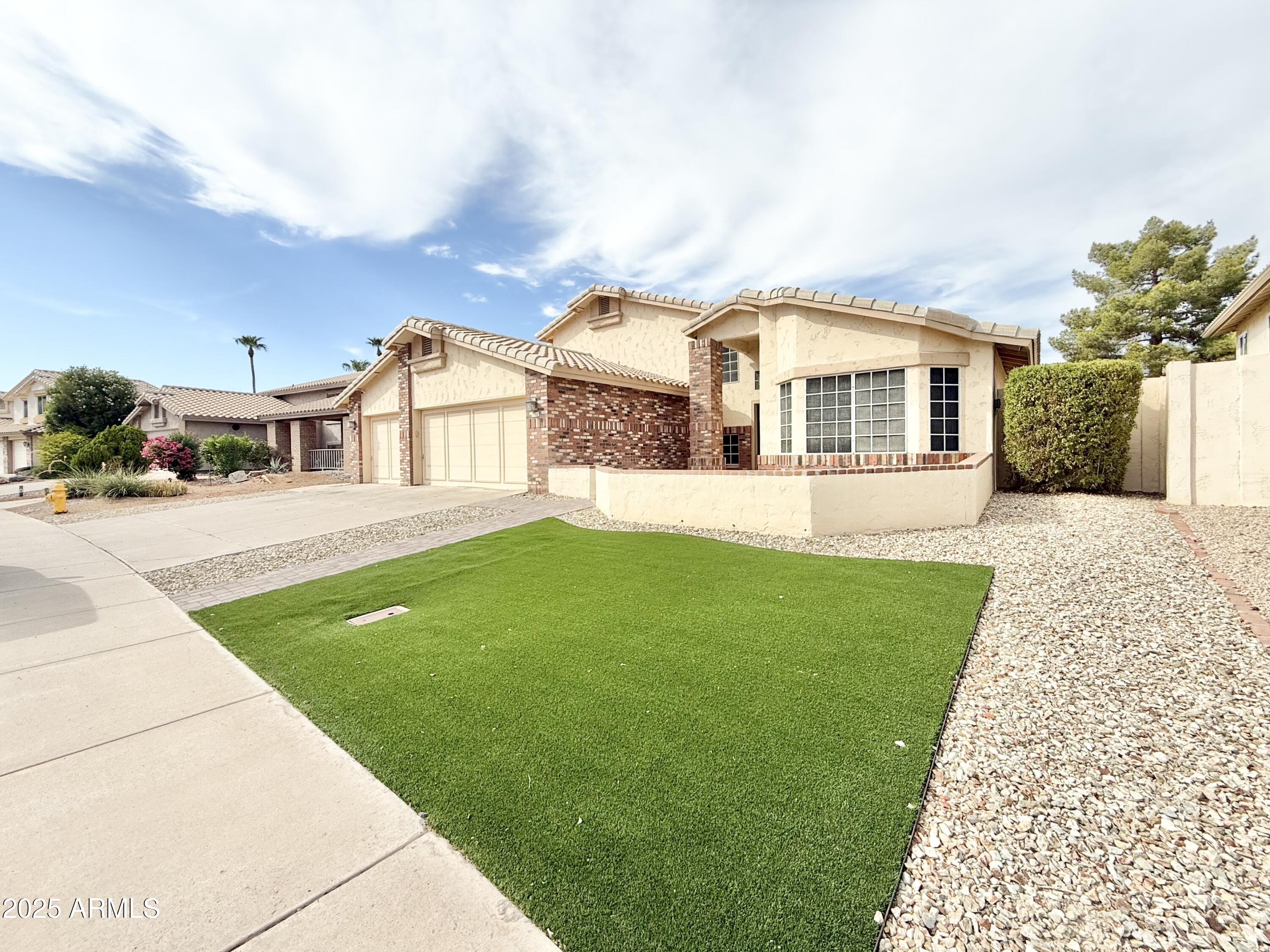 2718 East Bighorn Avenue Phoenix, AZ 85048 - Photo 2 of 31 a front view of a house with a garden and yard