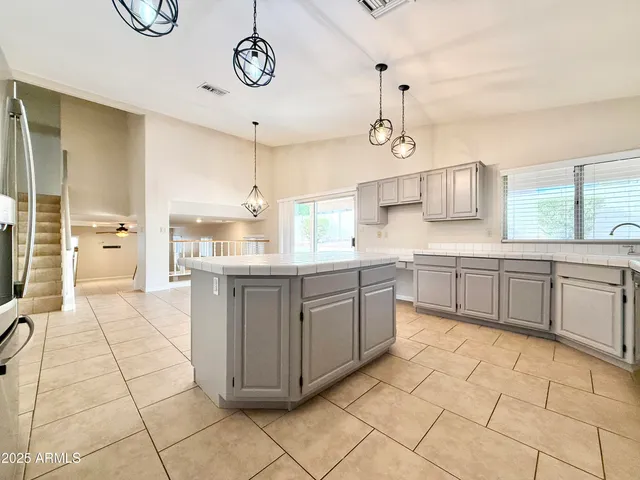 a large kitchen with cabinets and wooden floor