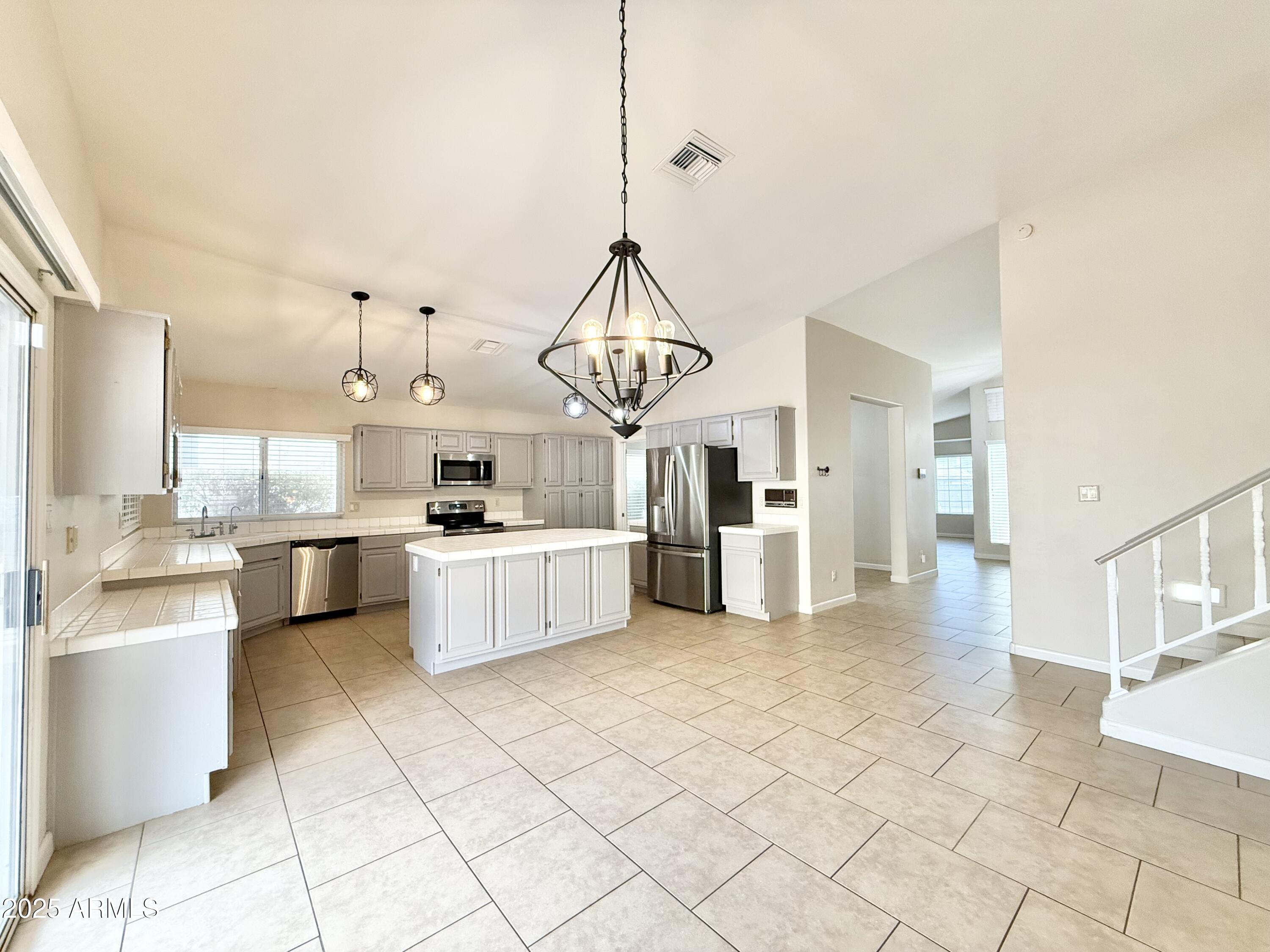 2718 East Bighorn Avenue Phoenix, AZ 85048 - Photo 7 of 31 a view of a kitchen with kitchen island stainless steel appliances cabinets a sink and a counter top