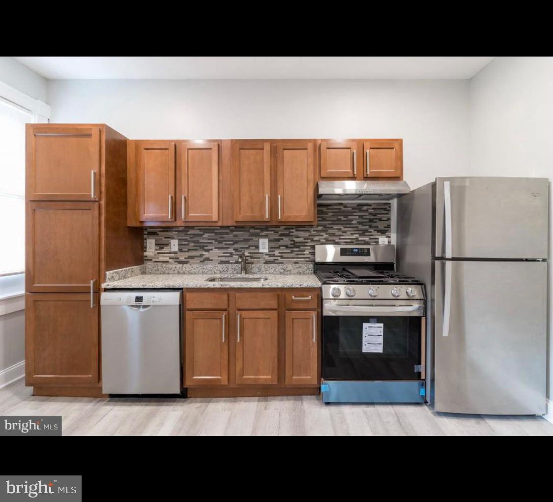 1626 Appleton Street Baltimore, MD 21217 - Photo 17 of 18 a kitchen with stainless steel appliances a refrigerator stove microwave and sink