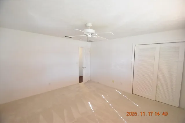 a bathroom with a granite countertop toilet sink and mirror