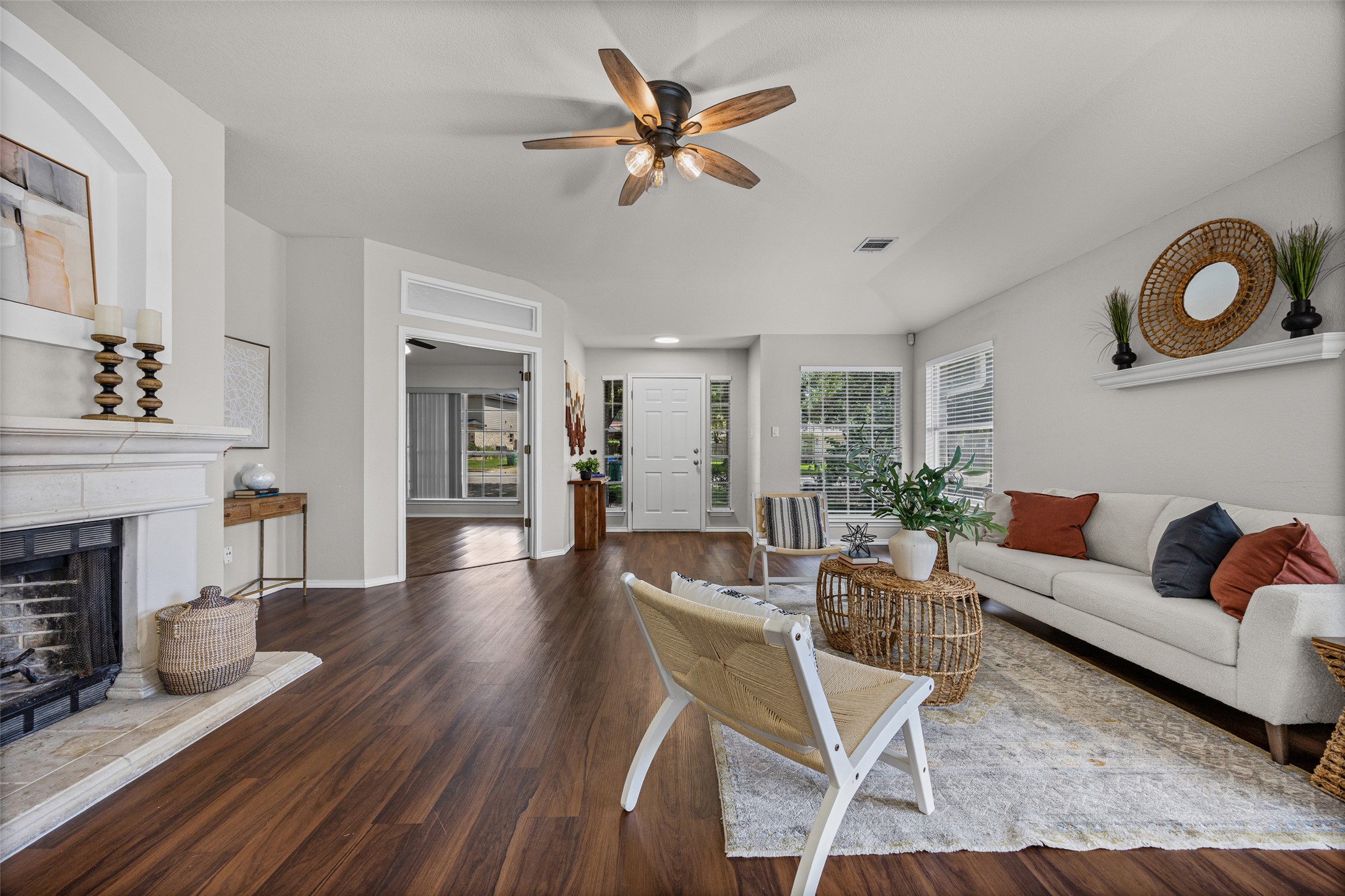1524 Lochaline Loop Pflugerville, TX 78660 - Photo 1 of 22 Warm wood flooring extends throughout this inviting living space with a stately fireplace.