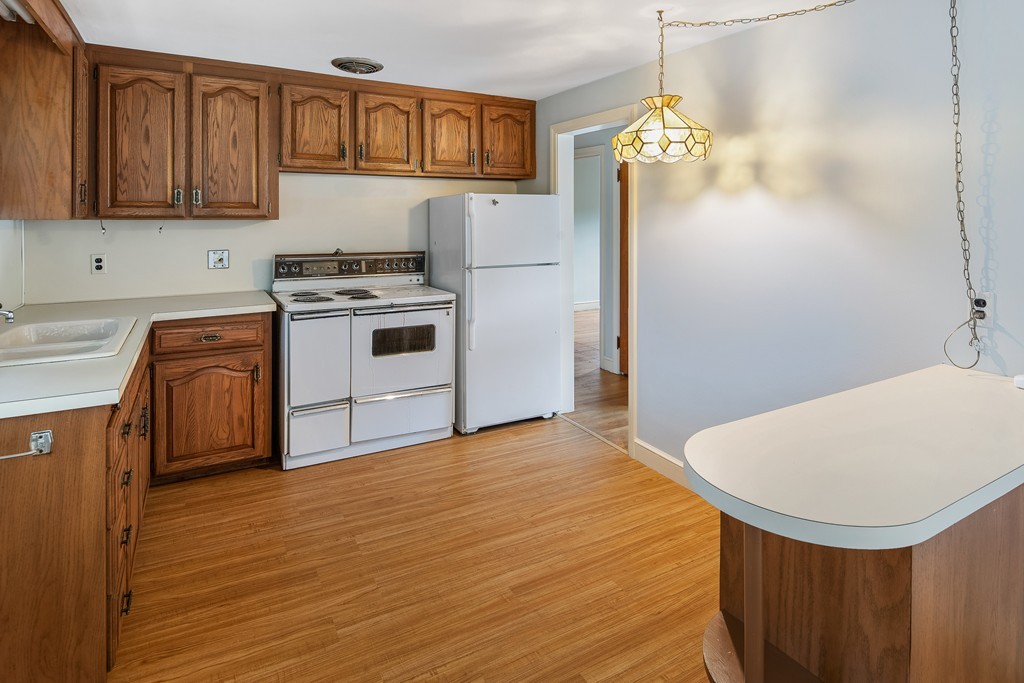 10 Wadsworth Road Arlington, MA 02476 - Photo 2 of 12 a kitchen with stainless steel appliances a stove a sink dishwasher and a refrigerator with wooden floor