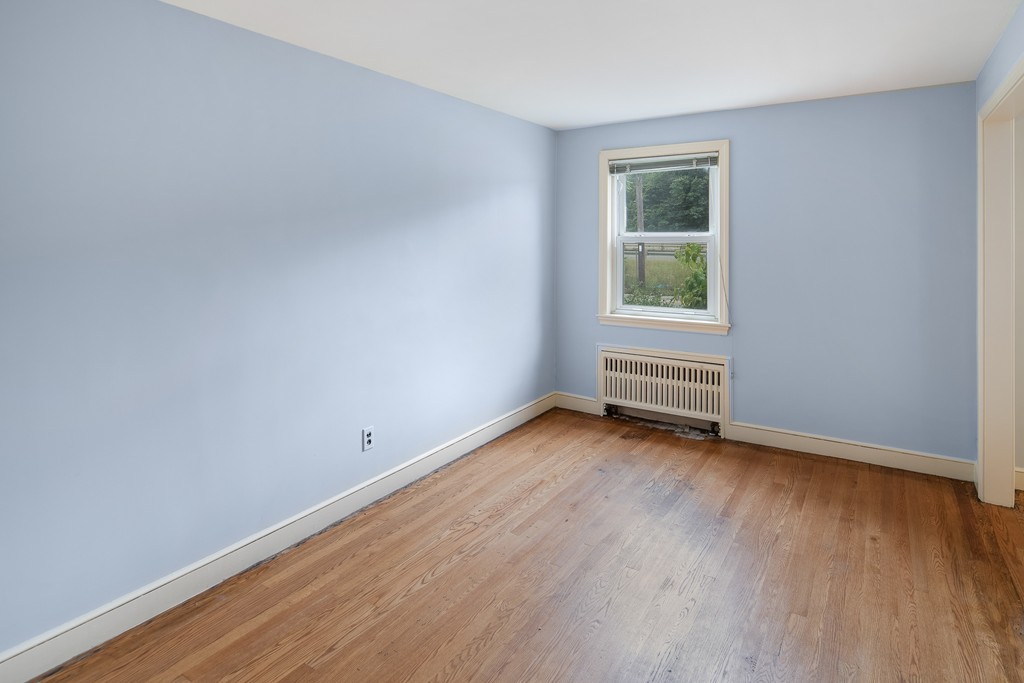 10 Wadsworth Road Arlington, MA 02476 - Photo 6 of 12 an empty room with wooden floor and windows