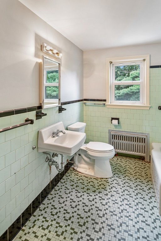 10 Wadsworth Road Arlington, MA 02476 - Photo 10 of 12 a bathroom with a sink toilet a mirror and shower