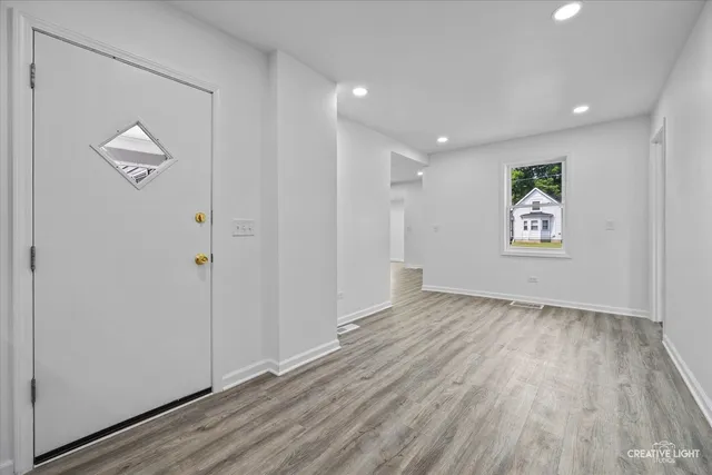 a view of room with window and wooden floor