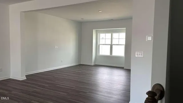a view of an empty room and wooden floor