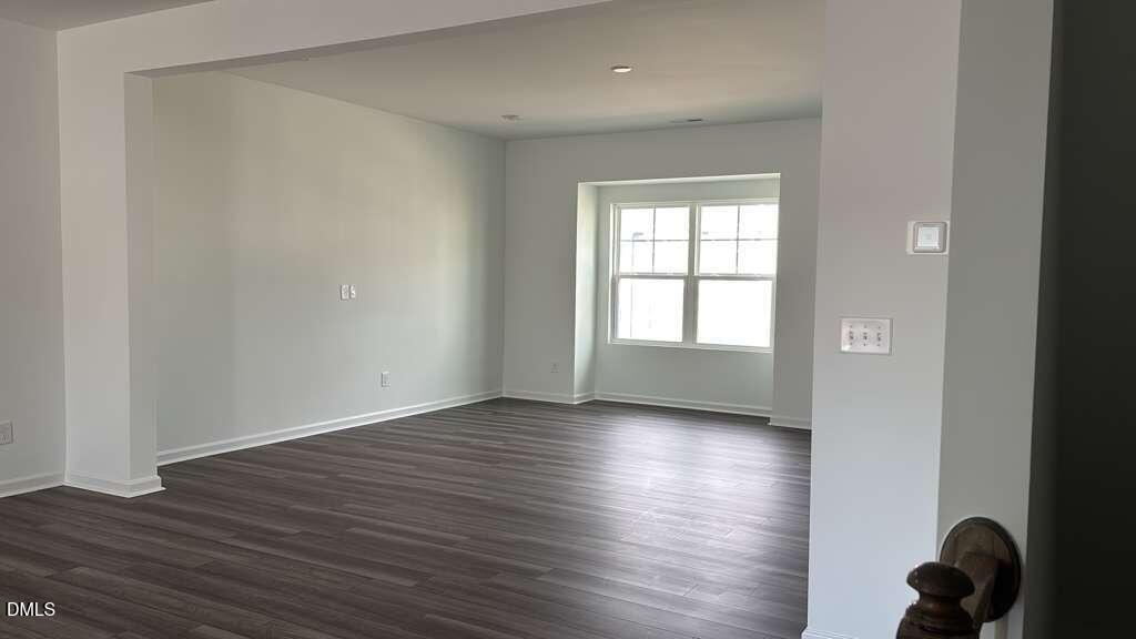 1443 Jay Road Knightdale, NC 27545 - Photo 14 of 46 a view of an empty room and wooden floor