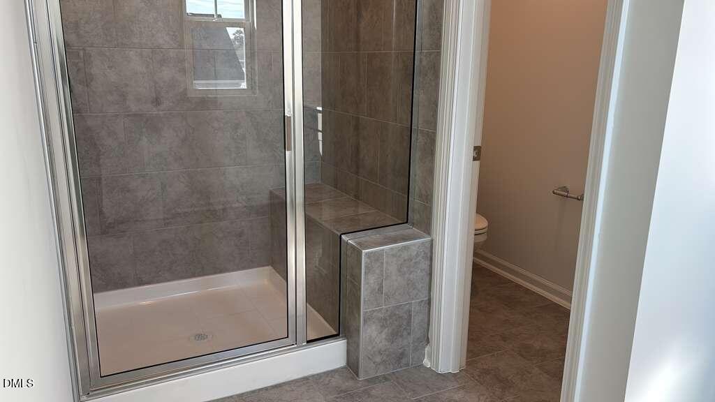 1443 Jay Road Knightdale, NC 27545 - Photo 25 of 46 a bathroom with a glass shower door