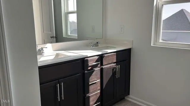a bathroom with a sink a vanity and a mirror