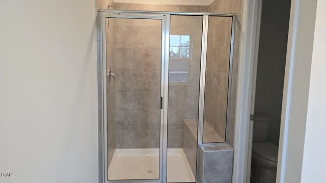 a bathroom with a glass shower door