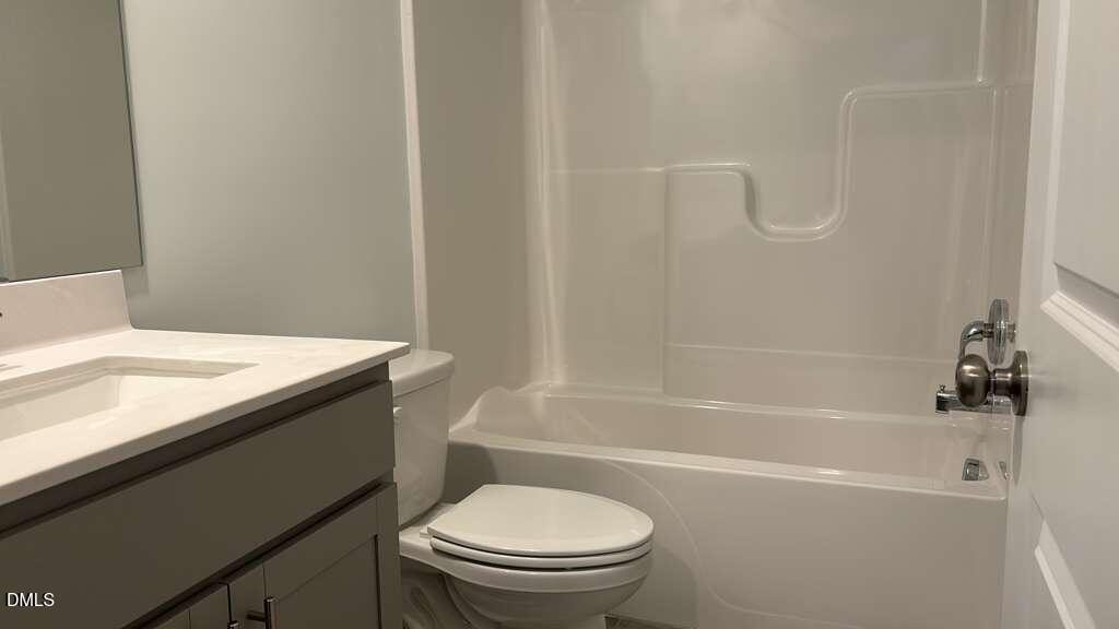 1443 Jay Road Knightdale, NC 27545 - Photo 39 of 46 a bathroom with a granite countertop sink toilet and bathtub