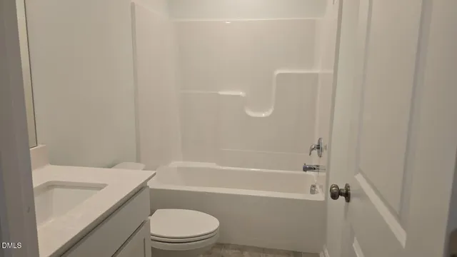 a bathroom with a toilet and a bathtub