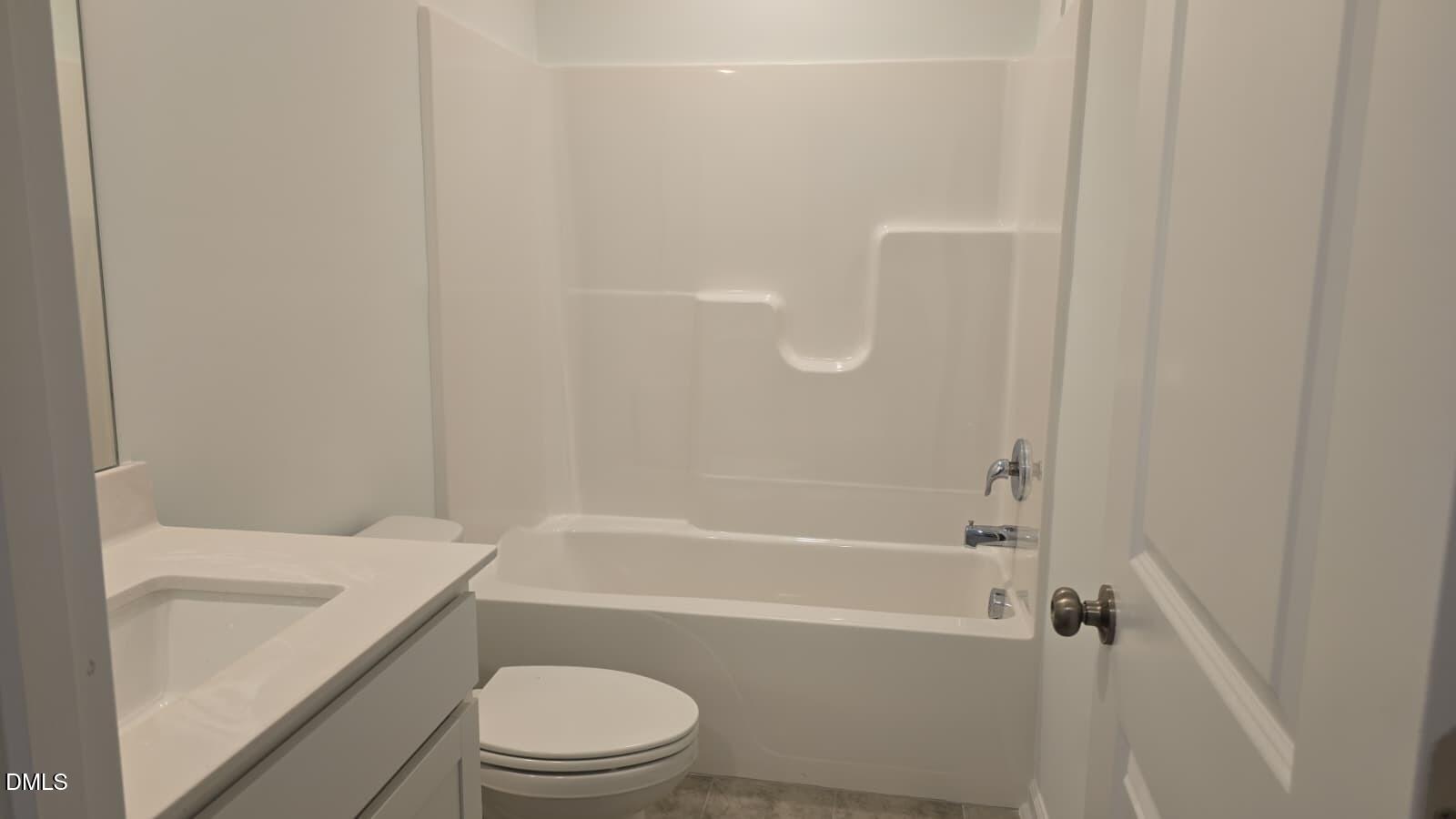 1443 Jay Road Knightdale, NC 27545 - Photo 9 of 46 a bathroom with a toilet and a bathtub