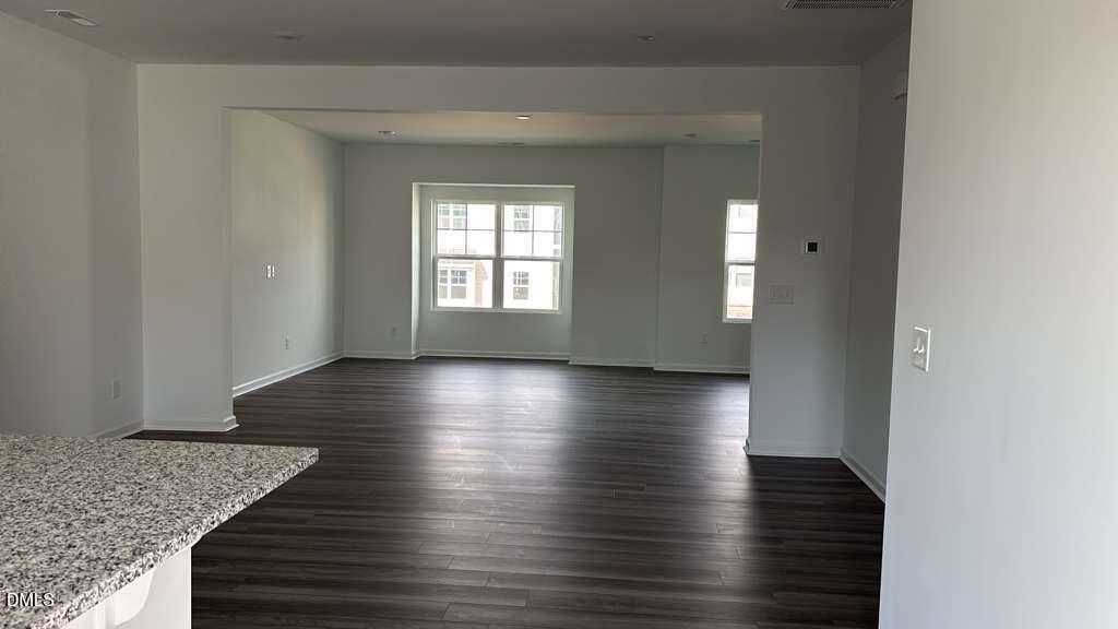 1443 Jay Road Knightdale, NC 27545 - Photo 10 of 46 an empty room with wooden floor and windows