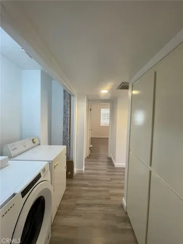 a view of a hallway with washer and dryer