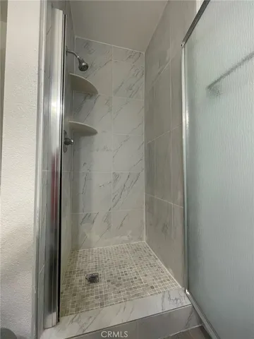 a bathroom with a glass shower door
