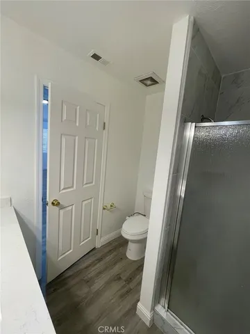 a bathroom with a toilet and a shower