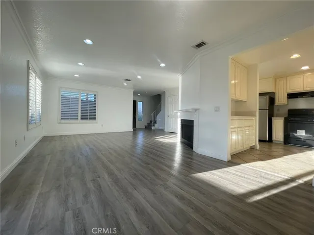 a view of a kitchen with a sink and a refrigerator