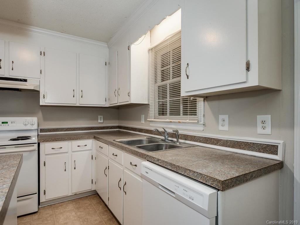 3310 Silver Stream Road, Unit 3310 Charlotte, NC 28226 - Photo 8 of 17 a kitchen with granite countertop white cabinets and a sink