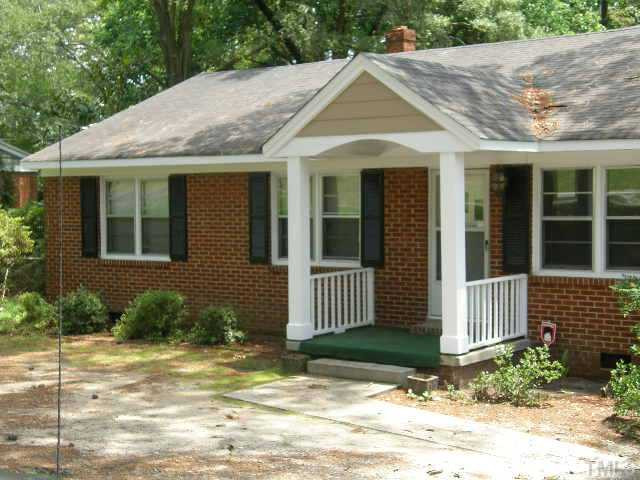 653 Sunnybrook Road Raleigh, NC 27610 - Photo 1 of 14 a view of a brick house with many windows plants and large tree