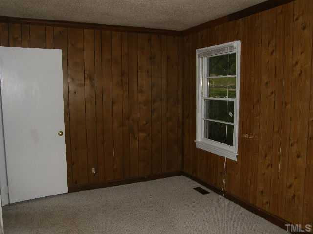 653 Sunnybrook Road Raleigh, NC 27610 - Photo 10 of 14 an empty room with windows