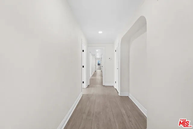 a view of a room with wooden floor
