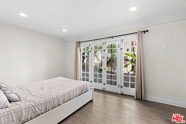 a bedroom with a large bed and a large window