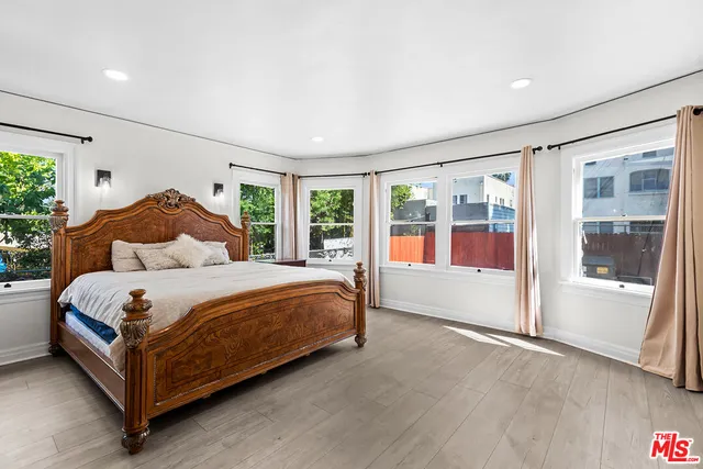 a bedroom with a large bed and a large window