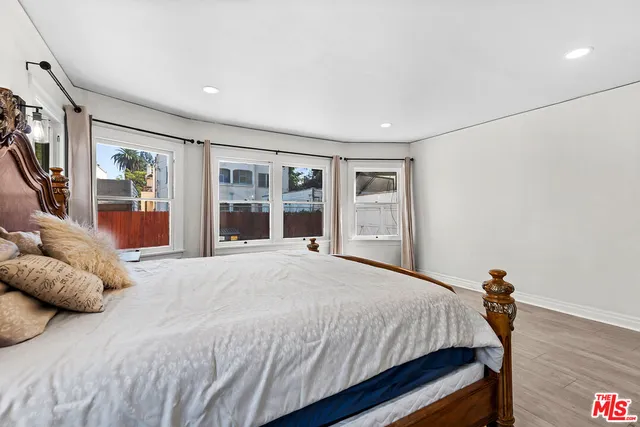a bedroom with a large bed and a large window
