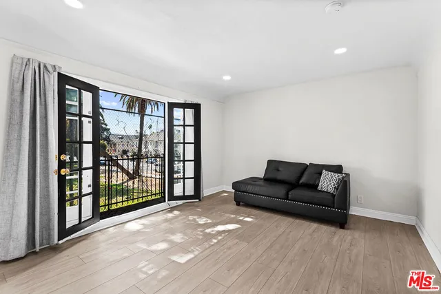 a living room with furniture and a floor to ceiling window