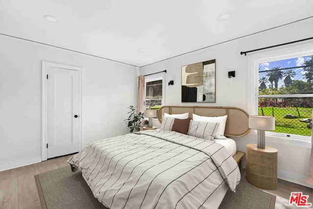 a bedroom with a large bed and a window