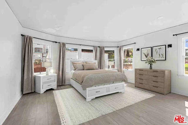 a bedroom with a large bed and a large window