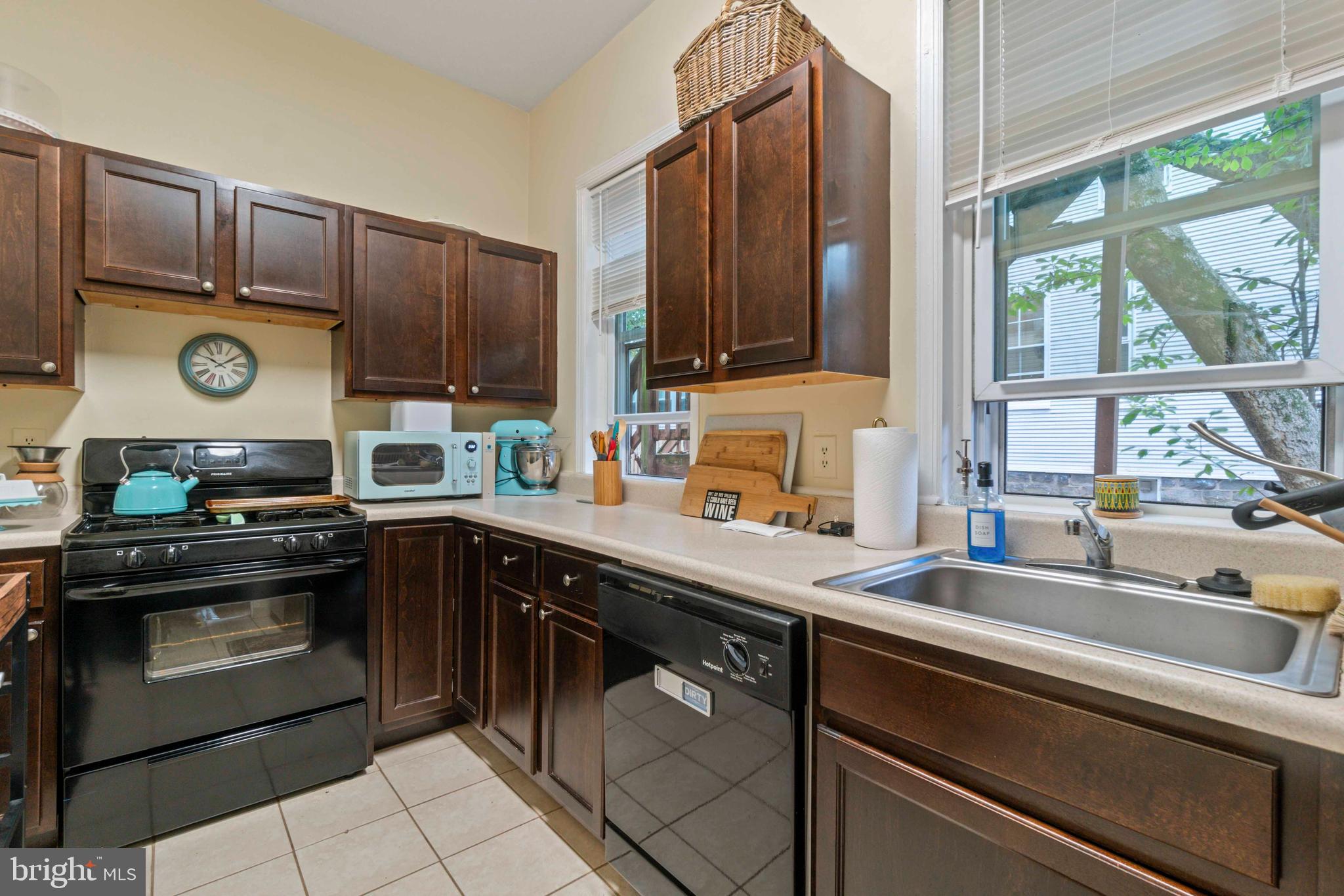 5009 Roland Avenue Baltimore, MD 21210 - Photo 14 of 35 a kitchen with stainless steel appliances granite countertop a sink a stove and cabinets