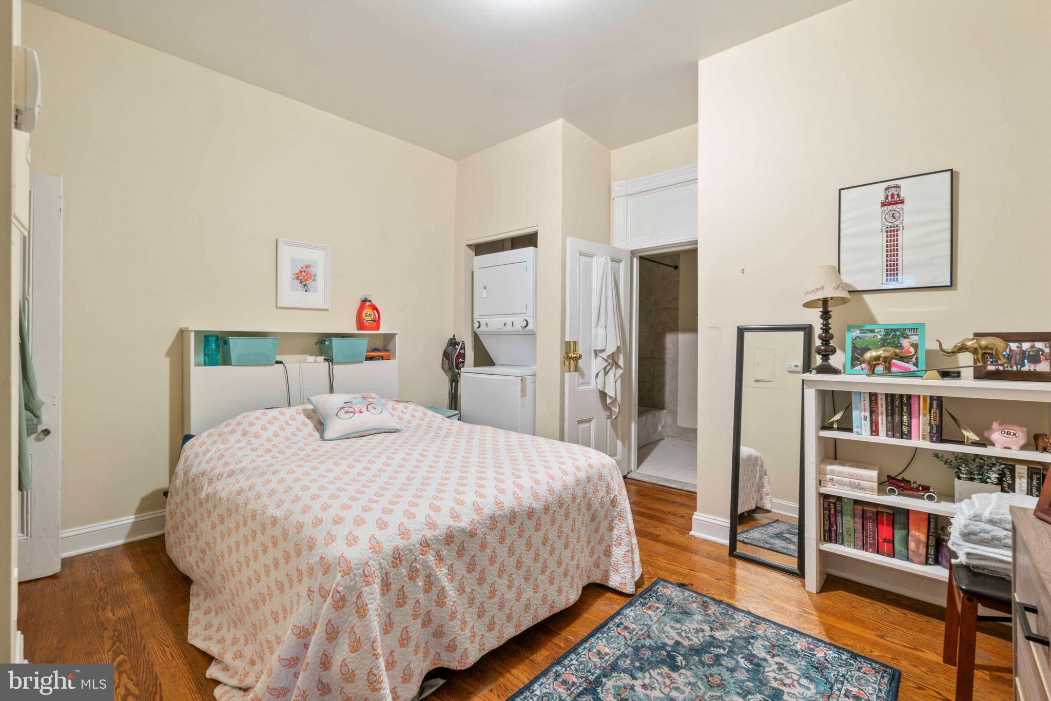 5009 Roland Avenue Baltimore, MD 21210 - Photo 15 of 35 a bedroom with a bed and a bookshelf