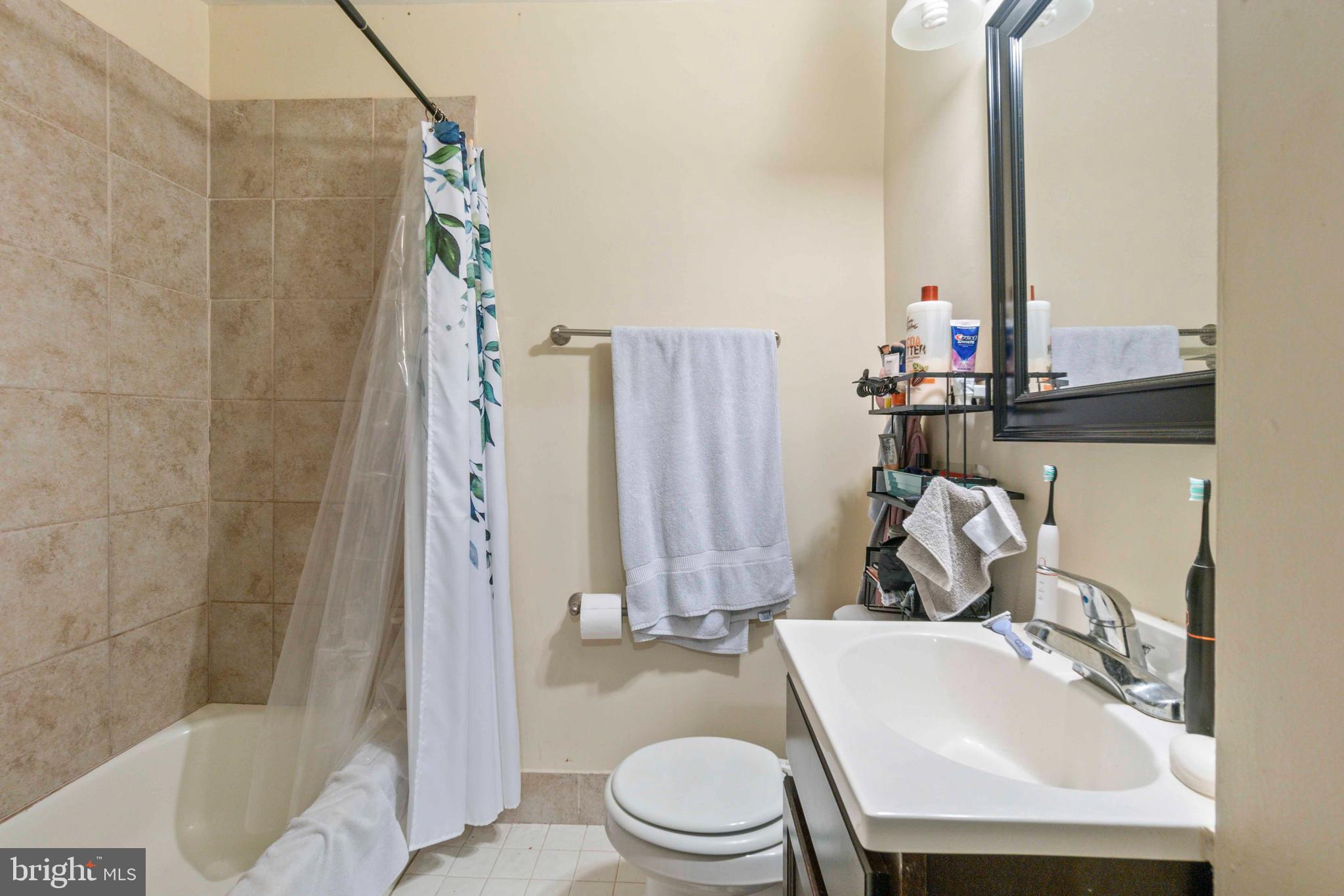 5009 Roland Avenue Baltimore, MD 21210 - Photo 18 of 35 a bathroom with a sink toilet and shower