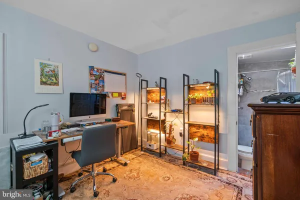 a bathroom with a granite countertop shower a sink and a mirror