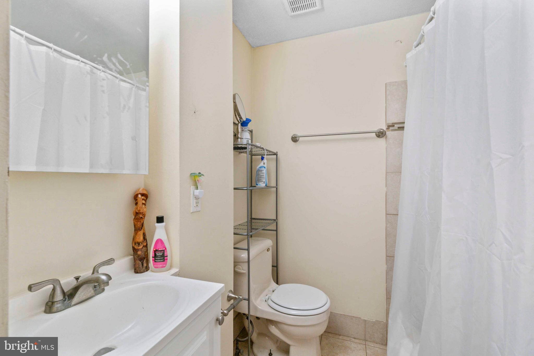 5009 Roland Avenue Baltimore, MD 21210 - Photo 26 of 35 a bathroom with a sink toilet and shower