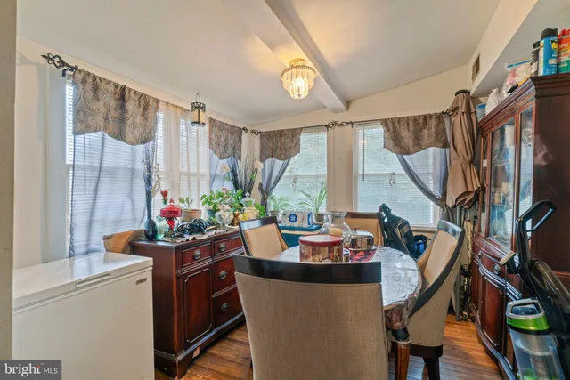 a view of a dining room with furniture and a window