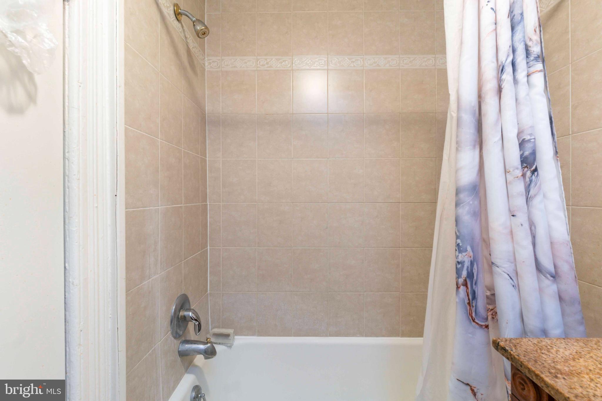 5009 Roland Avenue Baltimore, MD 21210 - Photo 7 of 35 a bathroom with a bathtub and shower