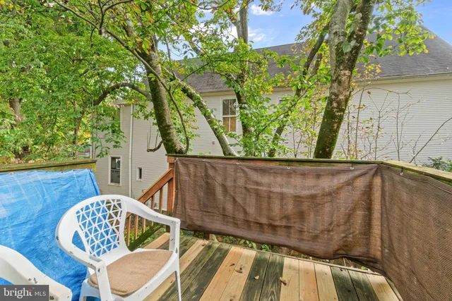 a living room with furniture and a book shelf