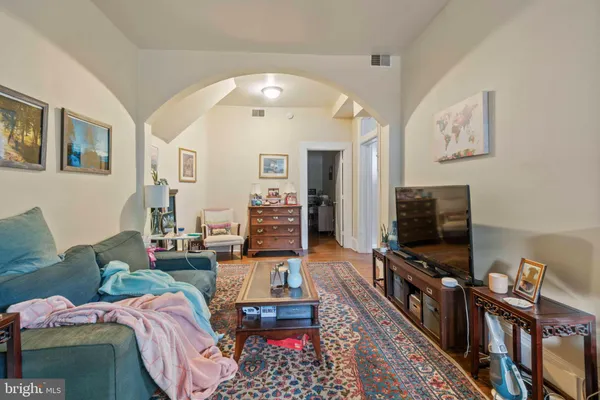 a living room with furniture and a baby crib