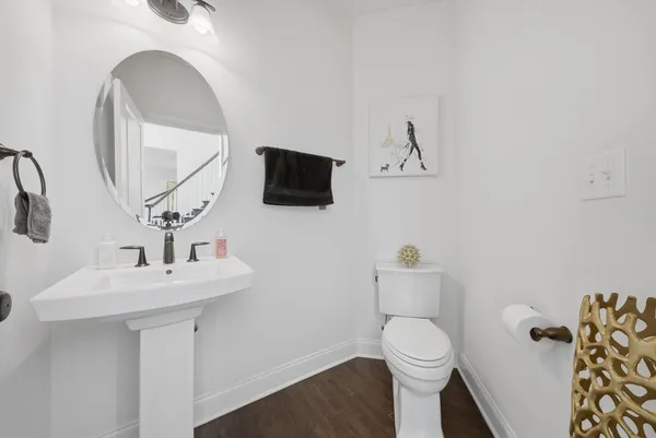 a bathroom with a toilet a sink and mirror