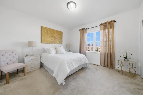 a spacious bedroom with a bed and a window