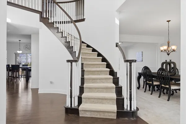a view of entryway and dining room with wooden floor