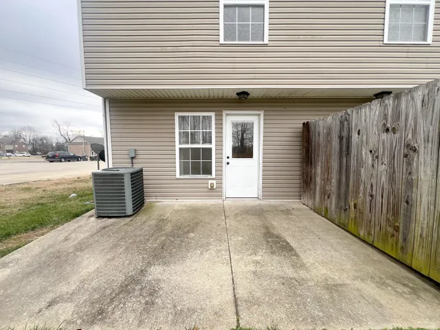 a view of a house with backyard and a yard