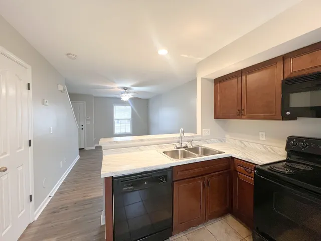 a kitchen with a sink stove and cabinets
